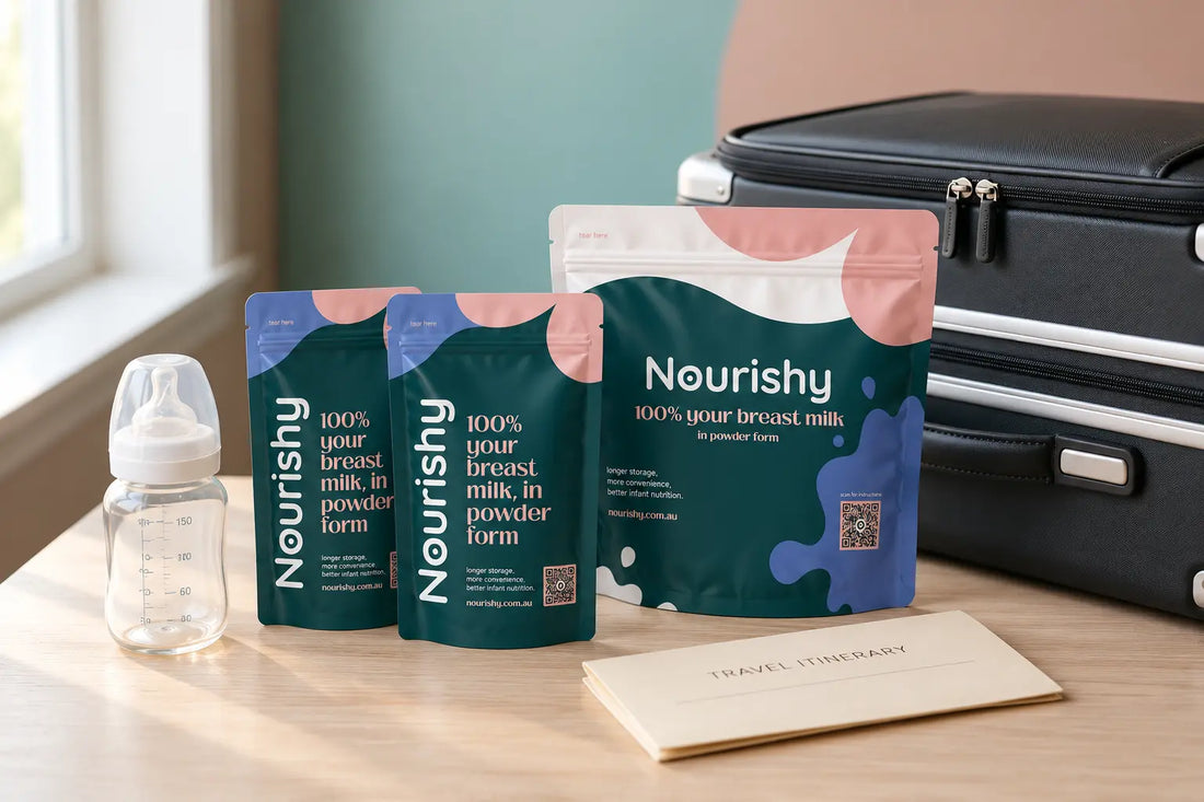 Sealed Nourishy freeze-dried breast milk pouches packed beside a carry-on bag for travel.
